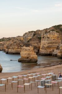 Tranquil beach scene with unique rock formations along the Lisbon coast.